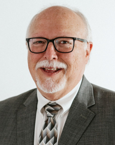 Headshot of Tony Burbach with a white background.