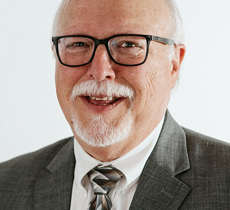 Headshot of Tony Burbach with a white background.