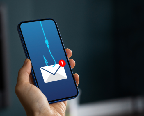 Hand holding a phone with an envelope on a hook.